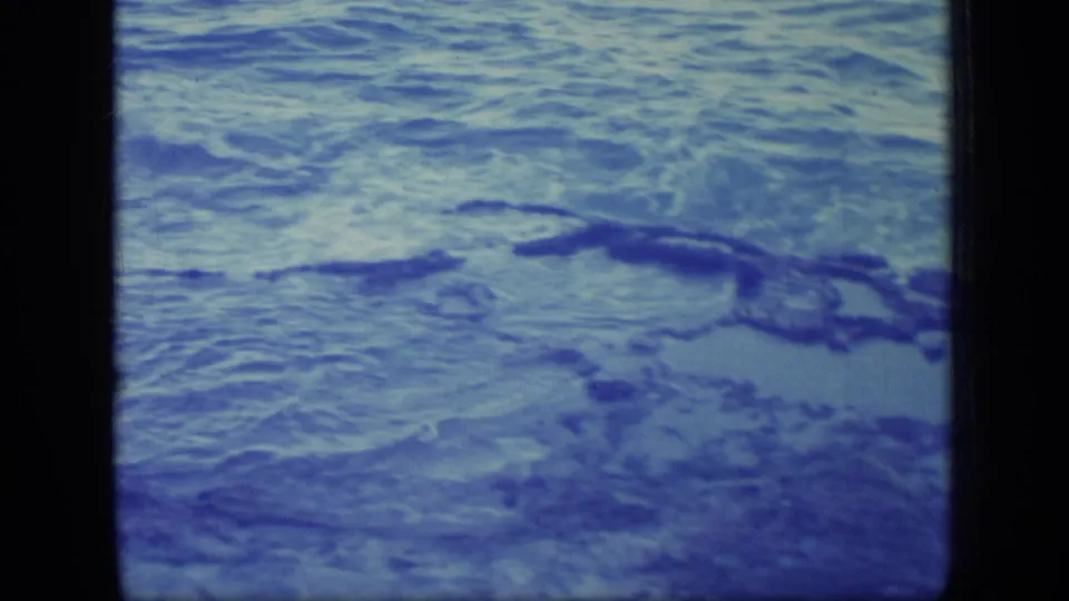 1970 Puerto Rico home-movie frame showing rippling ocean water with darker wave lines and film borders.