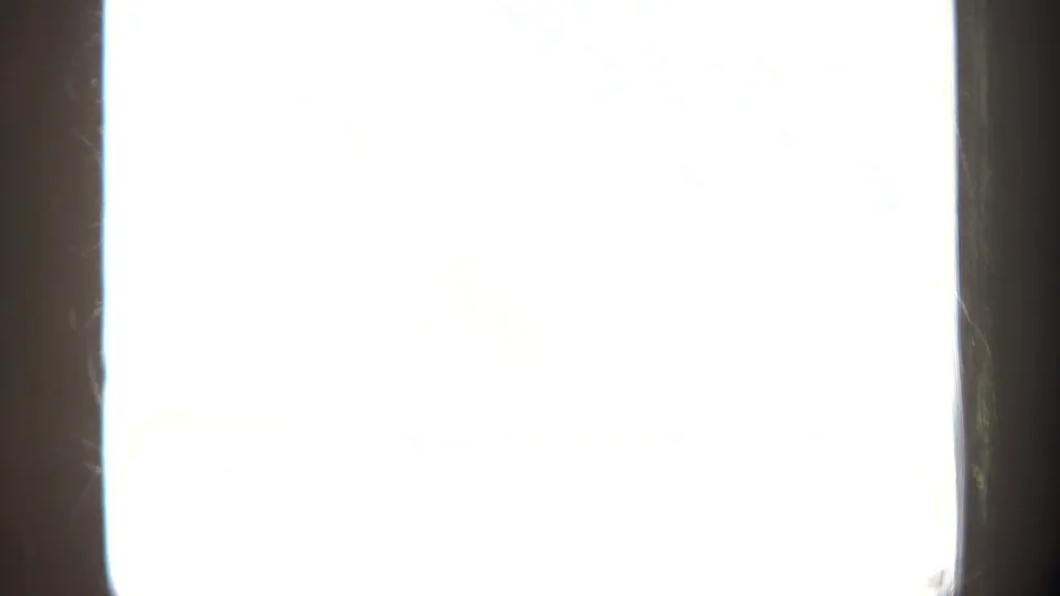 Overexposed end frame from the 8mm Puerto Rico clip, with a dark vertical film edge still visible.