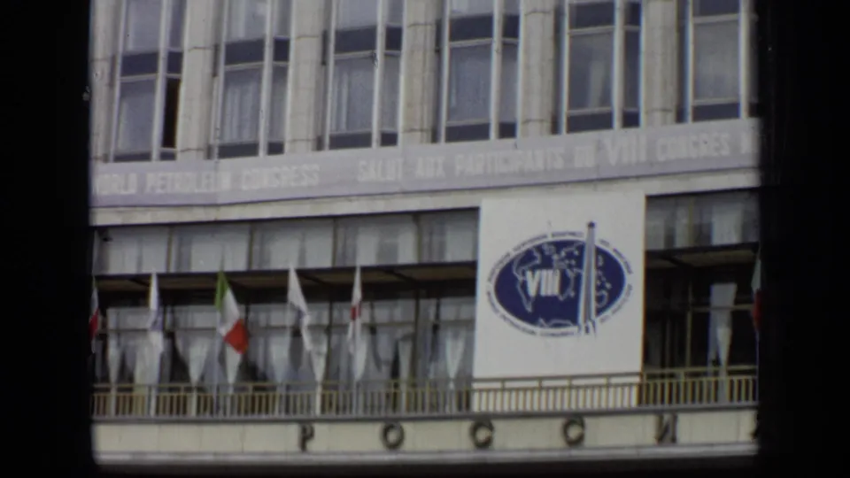 Wider 1971 Moscow 8mm view showing the VIII World Petroleum Congress banner below rows of windows, with flags along the building front.