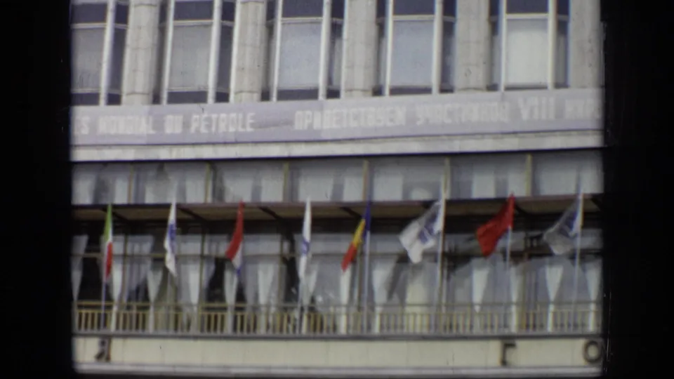 1971 Moscow building exterior with international flags mounted along a balcony beneath World Petroleum Congress banner text.