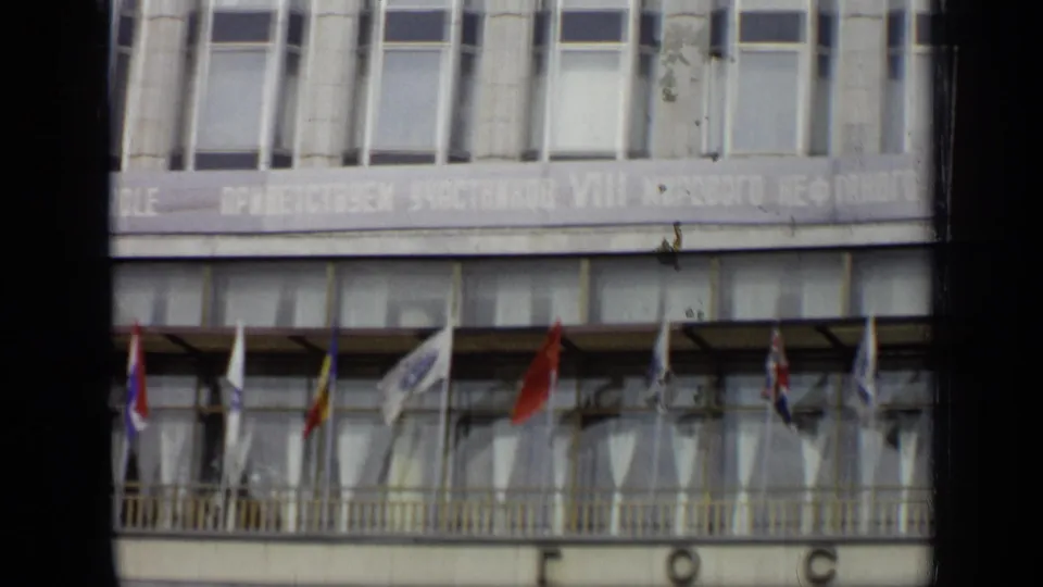 1971 Moscow conference building detail showing a partial congress banner, balcony railing, and several international flags.