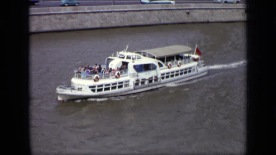 Later 1971 Moscow frame showing the same white passenger boat moving along the river with passengers still visible.