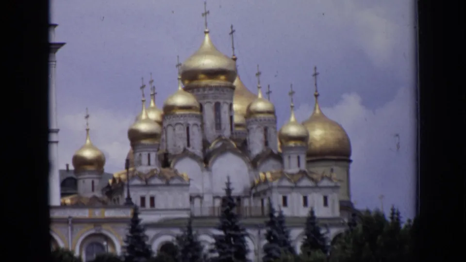 1971 Moscow view of a cathedral exterior with clustered gold domes, crosses, trees, and soft 8mm color.