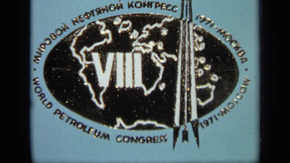 Blue Moscow 1971 petroleum congress emblem appears slightly tilted, with the black globe and bilingual text softened by 8mm grain.
