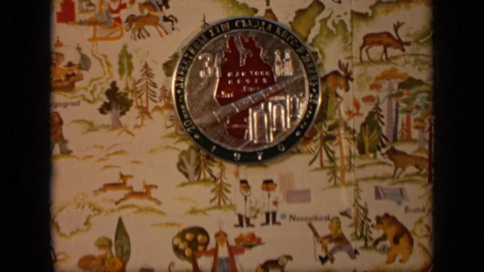 Round commemorative seal for the petroleum congress rests on an illustrated map with animals, trees, figures, and industrial motifs.