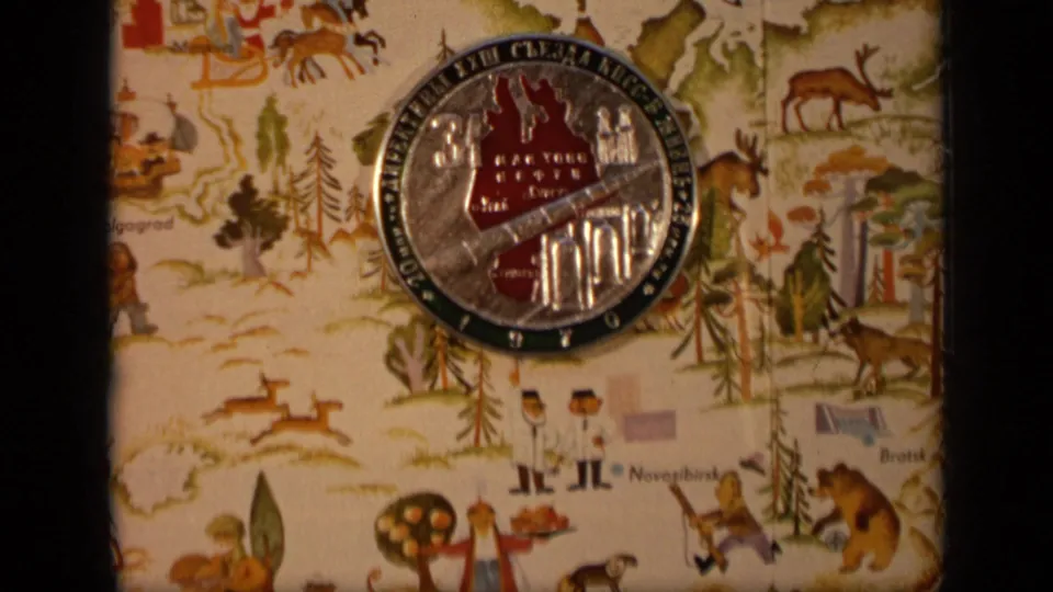 1971 Moscow 8mm frame of a commemorative Cyrillic coin on a colorful illustrated cloth showing wildlife, trees, and map-like place labels.