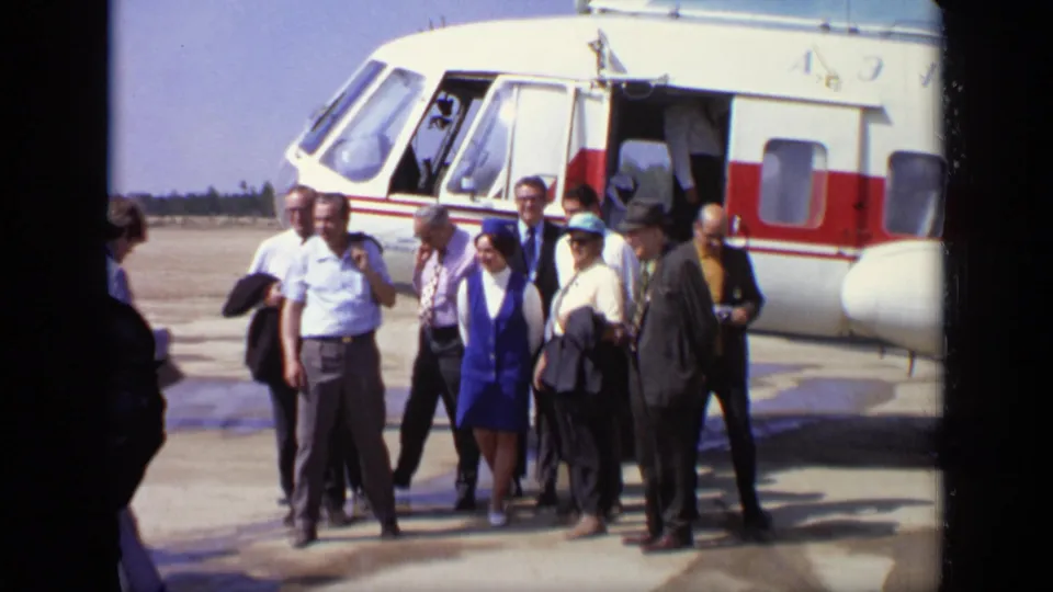 A wider 1971 Moscow view shows the helicopter, passengers, attendants, and onlookers gathered on a bright airfield.