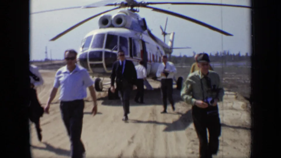 A 1971 Moscow airfield view shows passengers walking toward the camera while the helicopter remains parked behind them.