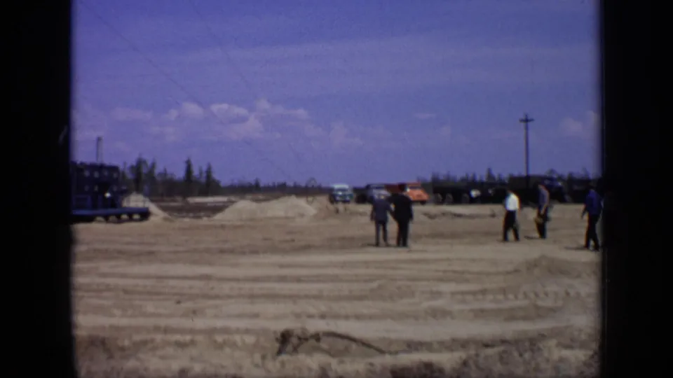 The final frame shows a broad Moscow construction area with men walking, dirt mounds, vehicles, utility poles, and trees on the horizon.