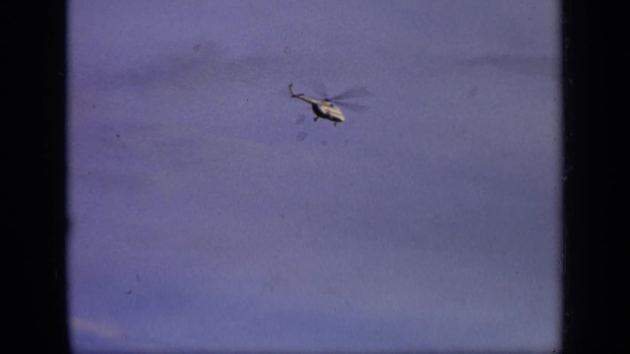 Small white helicopter appears in the sky in 1971 8mm footage attributed to the Moscow, Russia area.