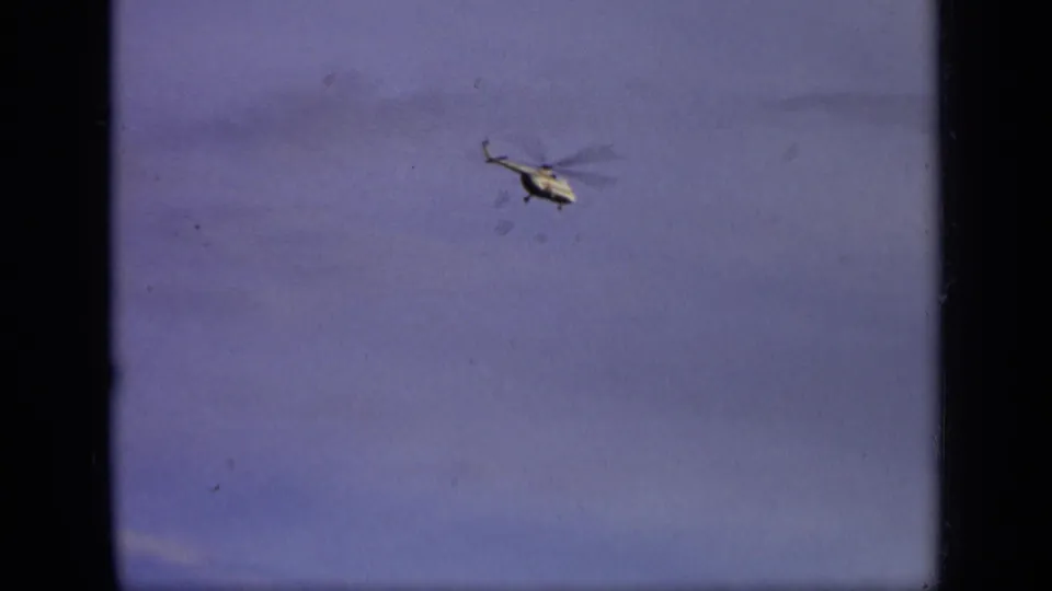Small white helicopter appears in the sky in 1971 8mm footage attributed to the Moscow, Russia area.