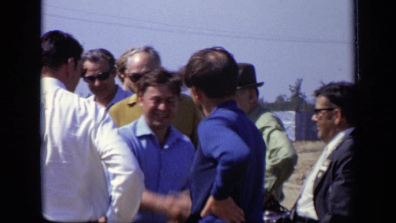 In the Moscow 1971 footage, men in blue and white shirts greet each other with a handshake among a small outdoor group.