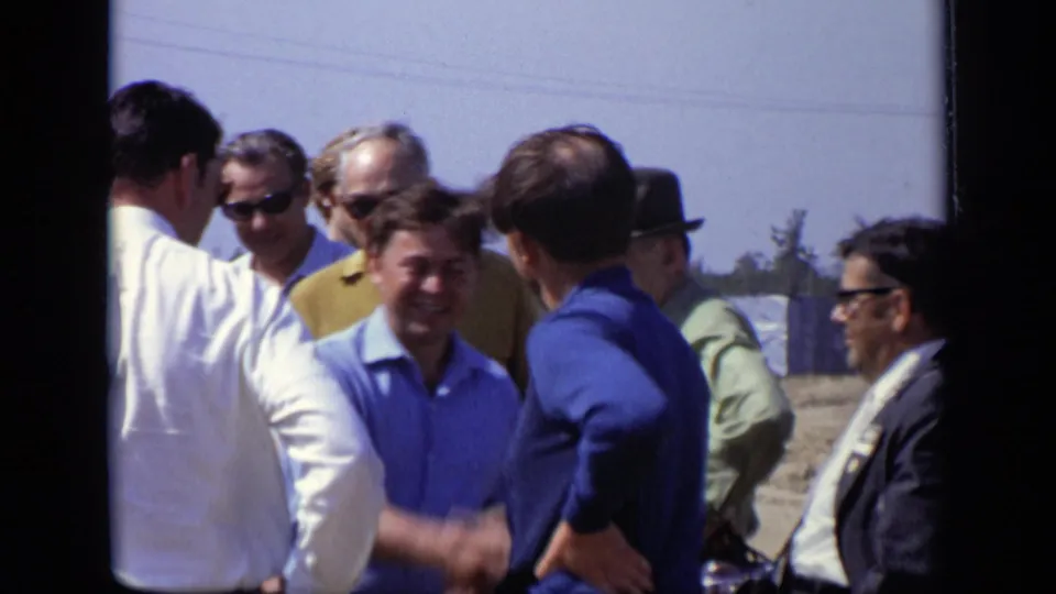 In the Moscow 1971 footage, men in blue and white shirts greet each other with a handshake among a small outdoor group.