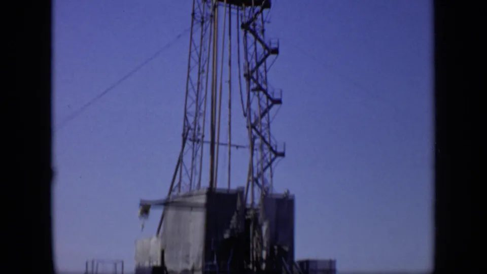 1971 Moscow frame showing the lower and middle sections of a tall lattice rig as the handheld camera pans upward.