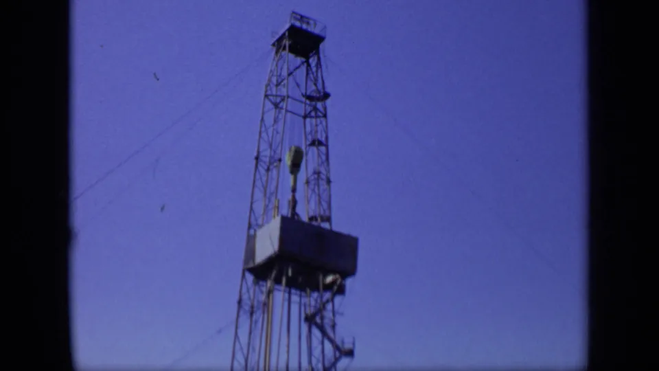 The rig remains framed from below, showing the tower structure, suspended equipment and platform in 1971 Moscow industrial footage.