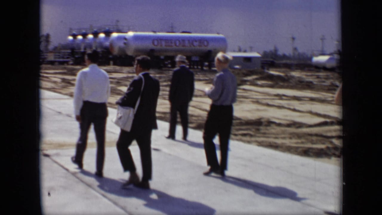 1971 Moscow industrial-site footage showing men in suits and white shirts near silver tankers marked in Cyrillic.