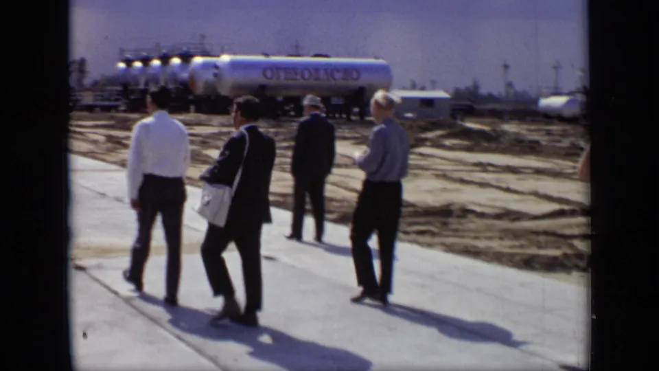 1971 Moscow industrial-site footage showing men in suits and white shirts near silver tankers marked in Cyrillic.