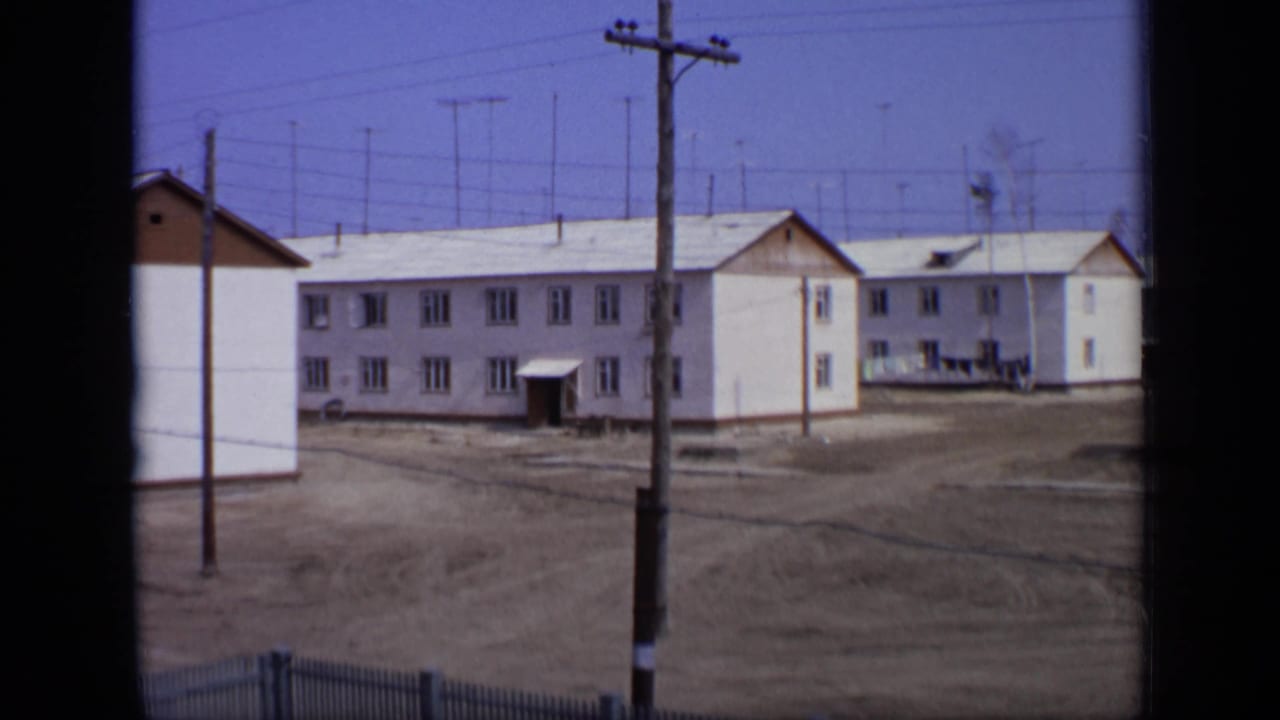A similar 1971 Moscow view of low-rise apartment blocks, open ground, utility lines, and roof antennas under a blue sky.