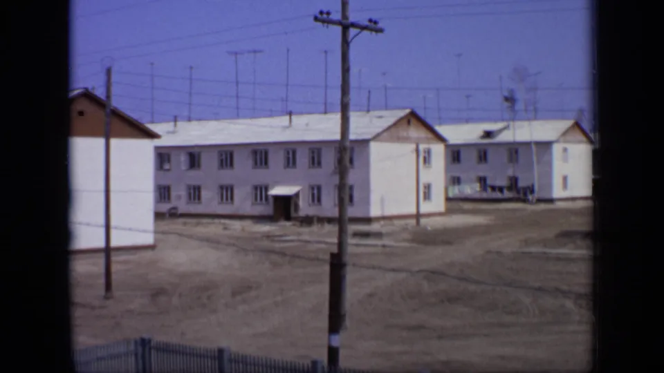 A similar 1971 Moscow view of low-rise apartment blocks, open ground, utility lines, and roof antennas under a blue sky.