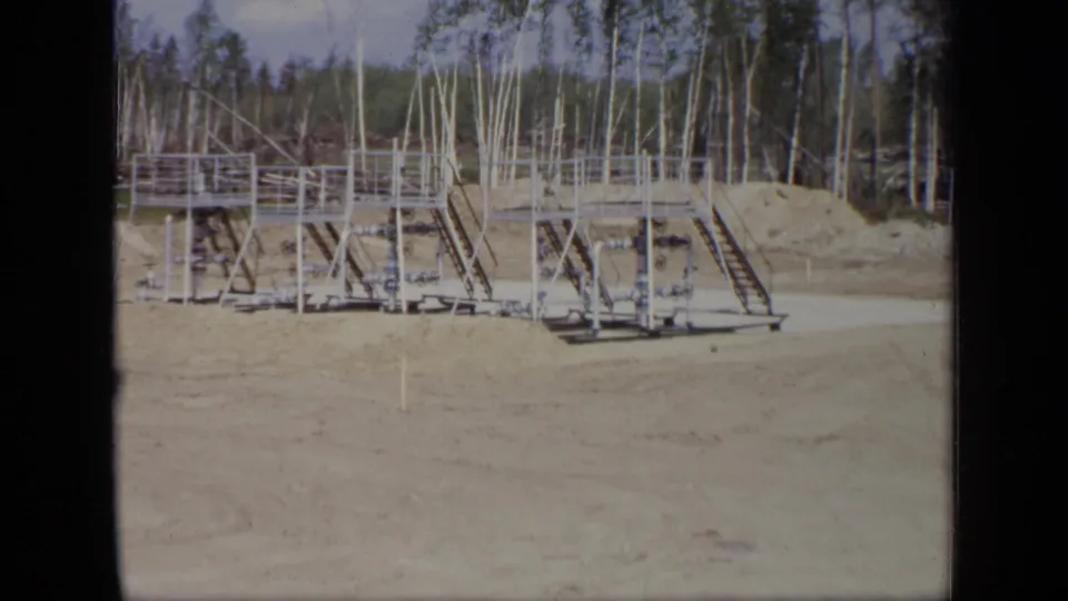 1971 Moscow industrial structure with connected metal platforms, railings, diagonal supports, and sparse trees behind.