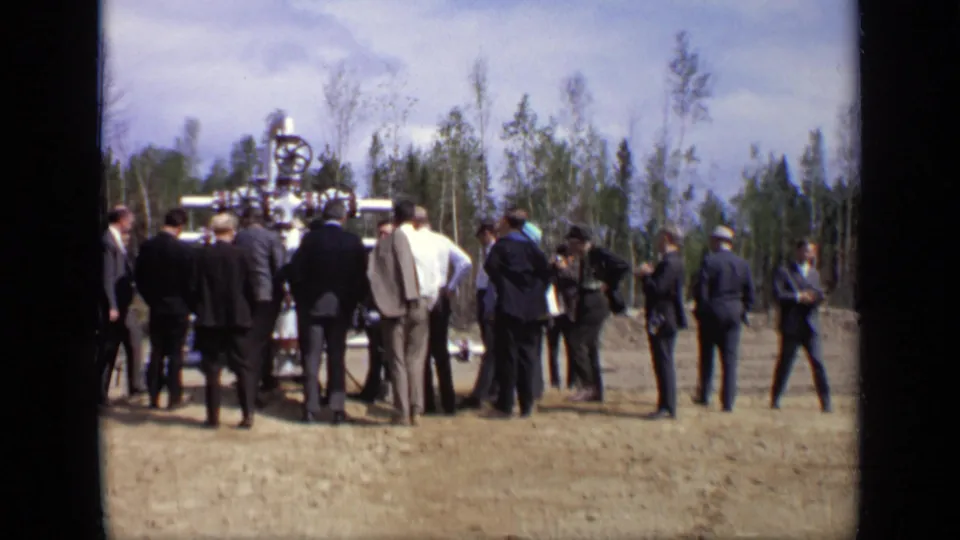 A wider 1971 Moscow view shows suited men standing around a large metal valve assembly in a sparse wooded clearing.