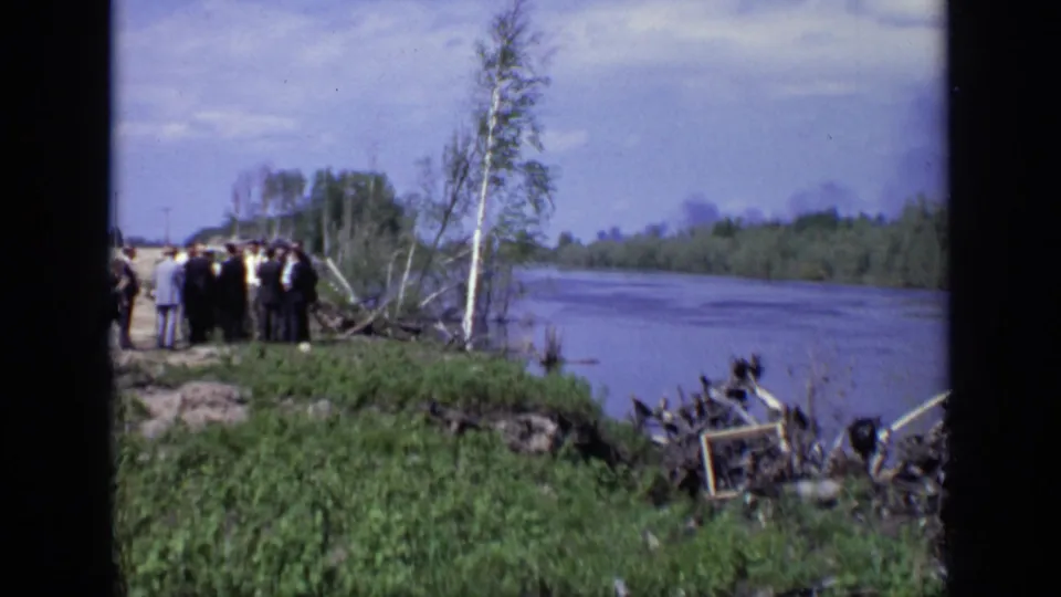 A wider 1971 Moscow-area riverbank view shows adults gathered near birch trees beside a broad river and wooded shoreline.