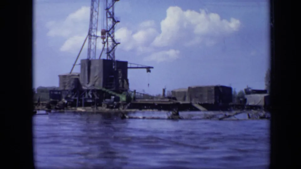 The final 1971 Moscow frame keeps the crane platform in view, with water, low industrial shapes, and bright clouds overhead.