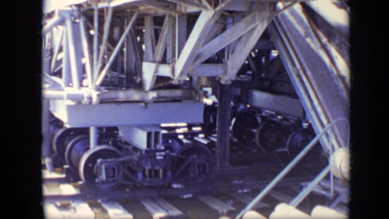 Heavy mechanical wheels and steel framing seen in a close industrial view.