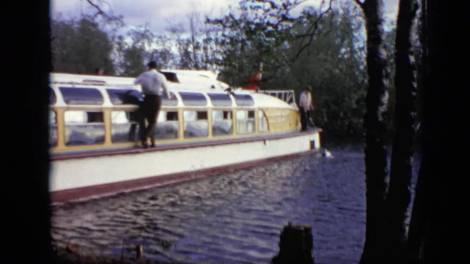 1971 Moscow river view of a passenger tour boat with visible people on deck and windows along the cabin.