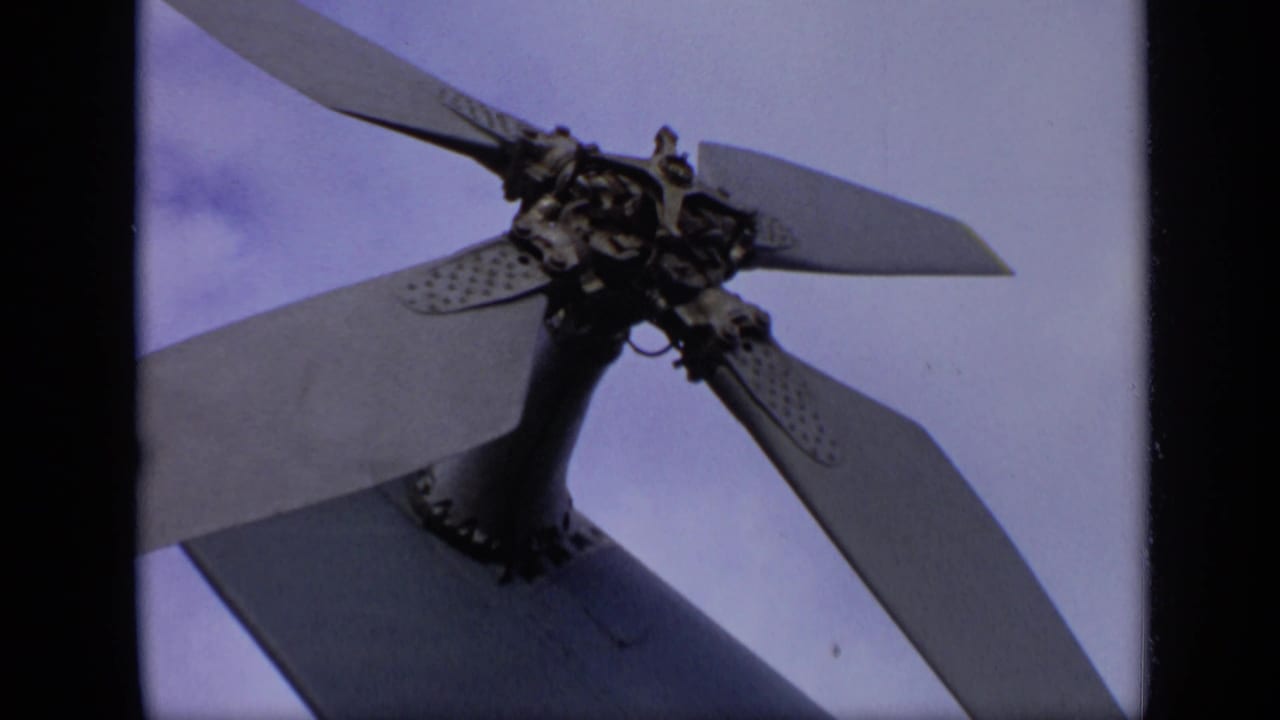 Close-up from the 1971 airfield footage shows the aircraft propeller hub and blades framed against a pale sky.