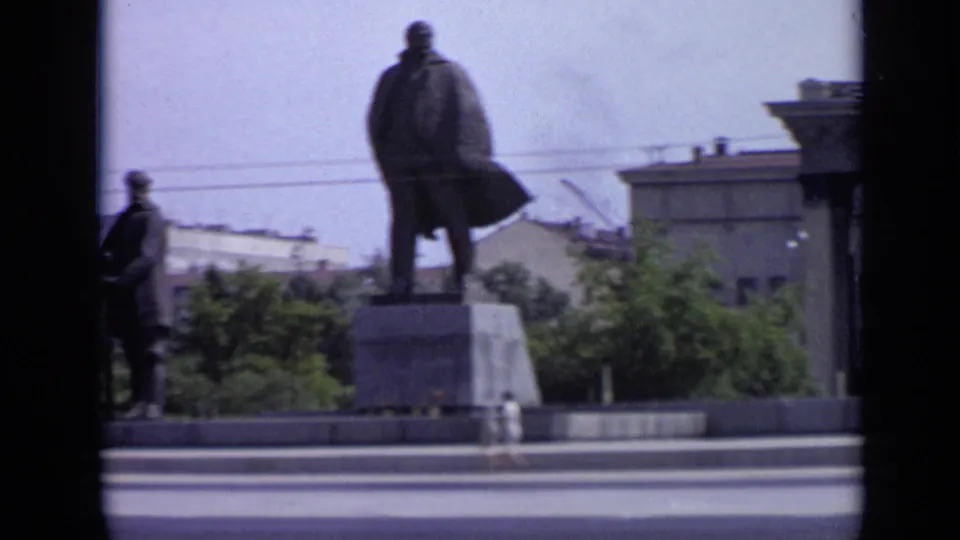 The Moscow monument remains framed from across the road, with the main statue on a pedestal and soldier figures partly visible.