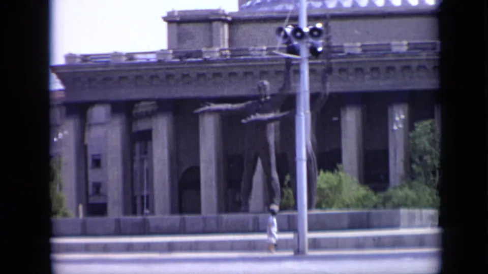 1971 Moscow view of a large public building with columns, a streetlight, pedestrians, and open roadway.