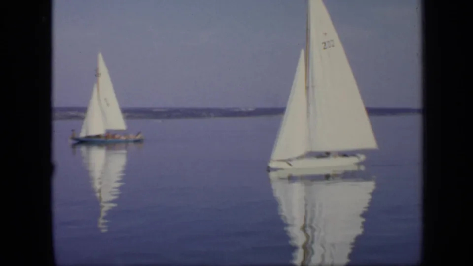 1971 Moscow 8mm frame showing two sailboats on still water, including a nearer white sail with a visible sail number.