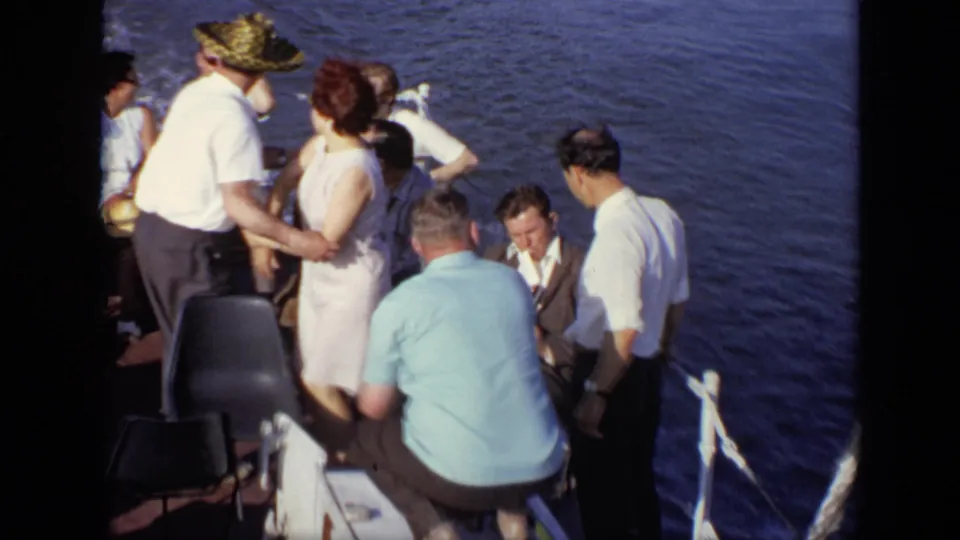 A closer 1971 Moscow boat-deck view shows adults standing and sitting near the rail with open water behind them.