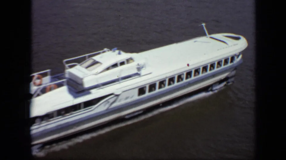 White passenger ferry cruising on a Moscow river in 1971, with small passengers visible on the open rear deck.