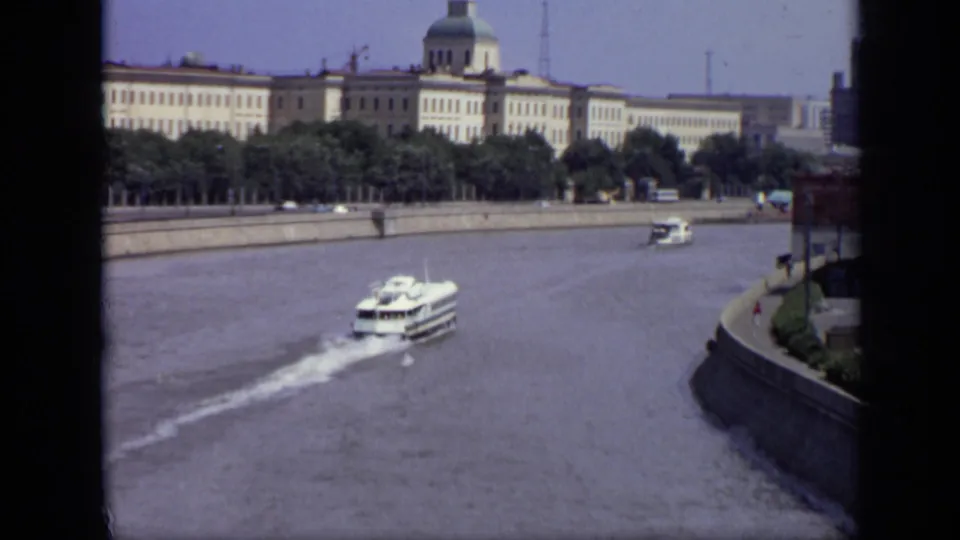 Final 1971 Moscow frame showing the ferry farther down the river near a curved embankment and tree-lined buildings.