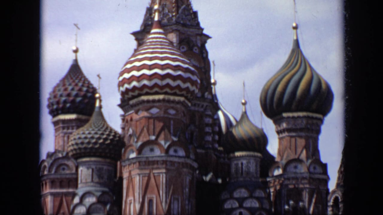 Saint Basil's Cathedral domes fill the frame with dark film borders at the sides.