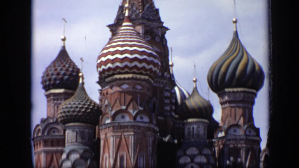 Tight 1971 Moscow view of Saint Basil's Cathedral, with patterned domes and brick towers softened by 8mm film grain.
