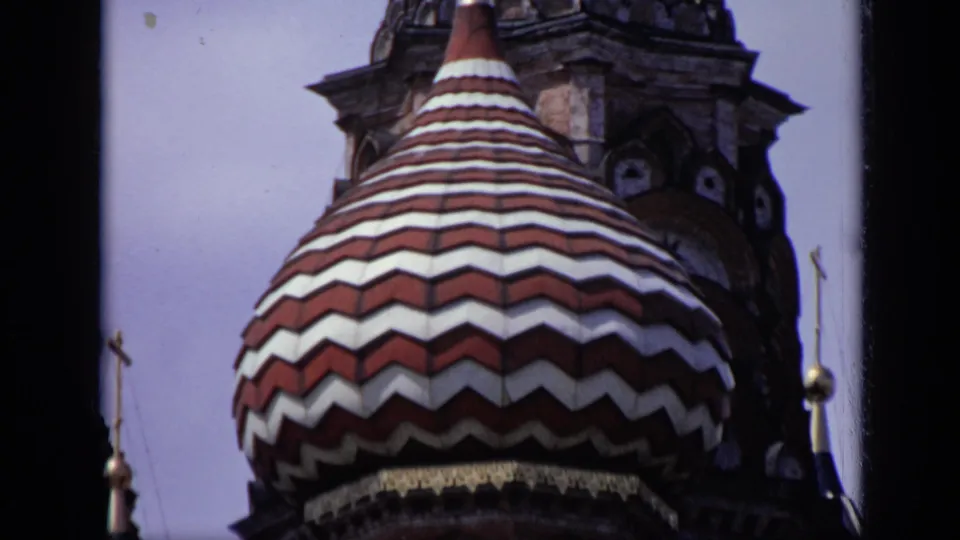 1971 Moscow 8mm close-up of a striped St. Basil's Cathedral onion dome with tower masonry and small spires visible.