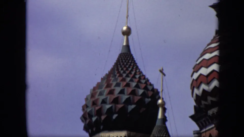1971 Moscow frame of a dark pyramid-tiled onion dome at St. Basil's Cathedral, with another striped dome partly visible.