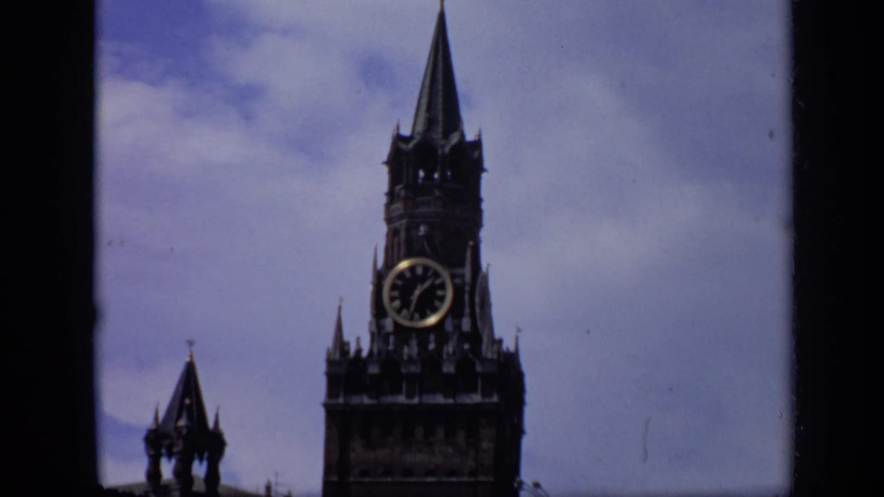Closer view of Spasskaya Tower with its clock face against the sky.