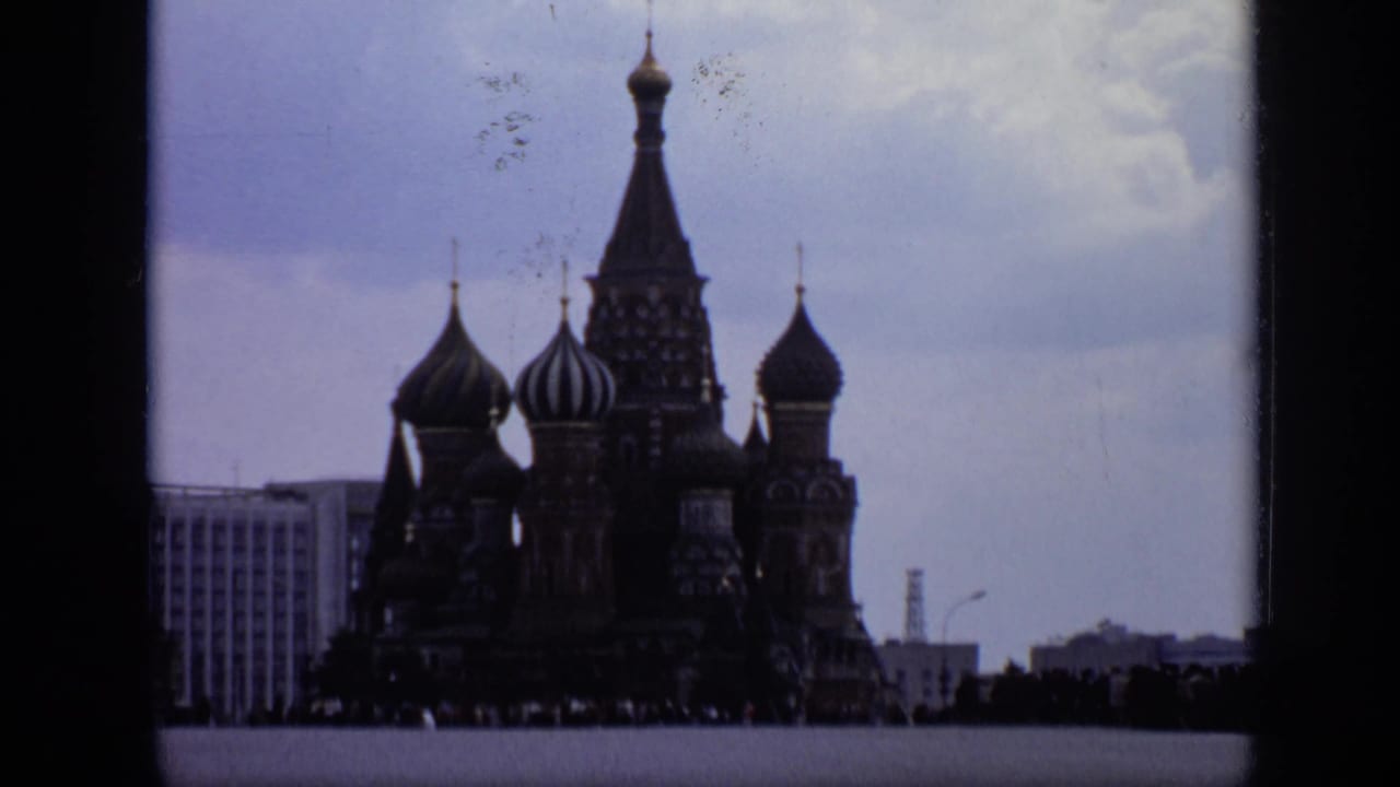 St. Basil's Cathedral silhouetted under a cloudy sky with film frame borders.