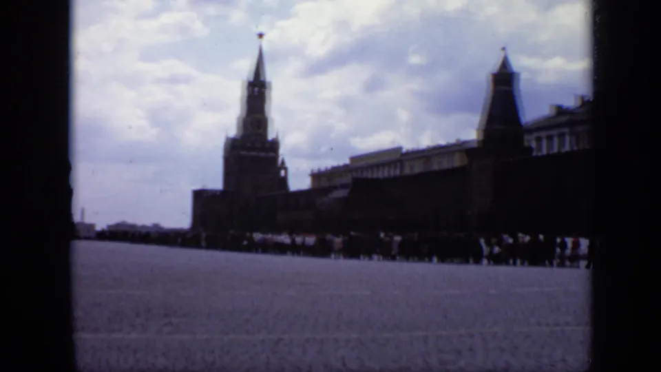 1971 Moscow frame with Spasskaya Tower, the Kremlin wall, broad paving, and visitors at the far side of Red Square.