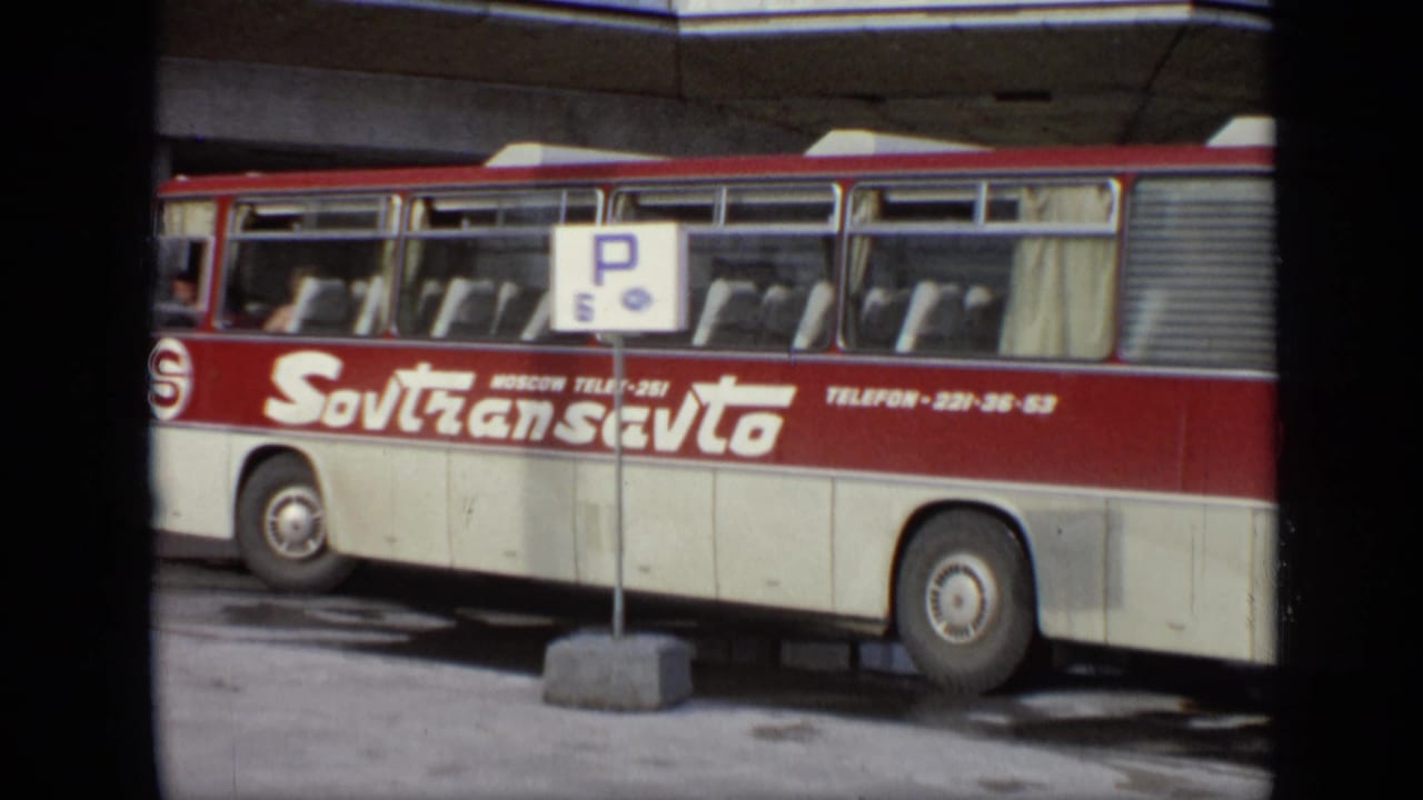 1971 Moscow street view showing a red and cream Sovtransavto coach at a stop, with a P 6 sign and seated passengers visible.