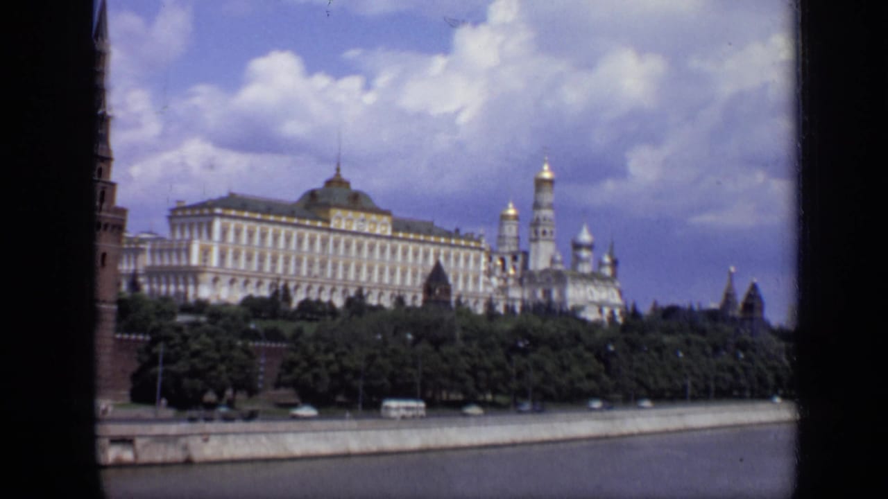 Kremlin buildings seen across the river behind trees and an embankment road.