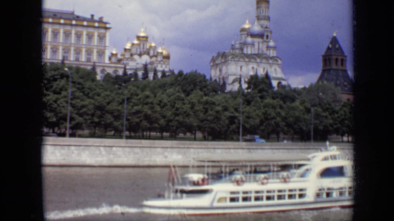 Tourist boat continues along the river with Kremlin towers and domes in the background.