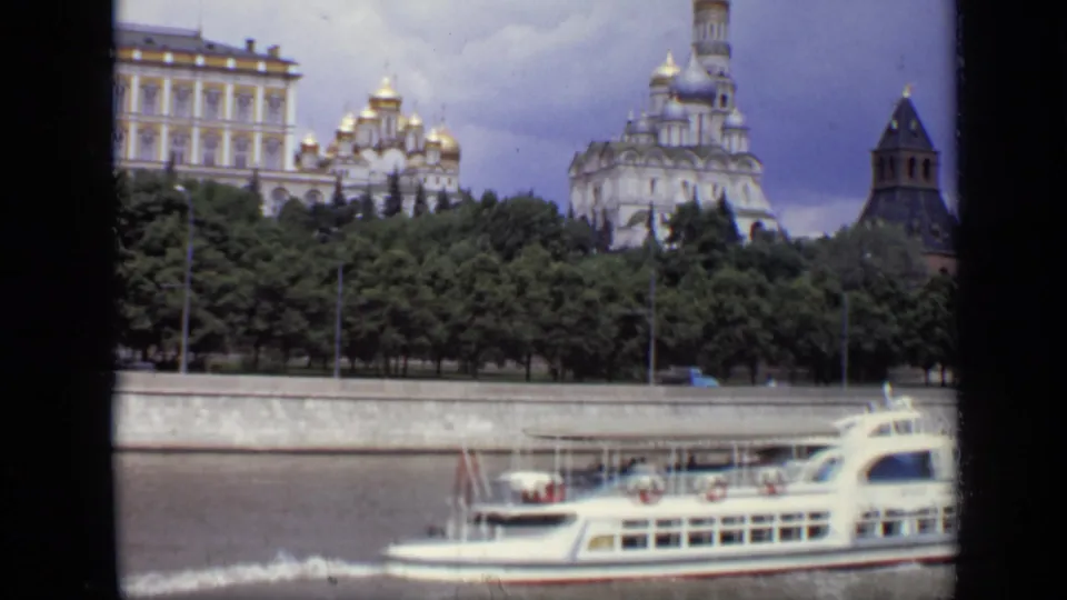 Moscow River boat scene with Kremlin architecture, trees, and cloudy sky visible in 1971 8mm footage.