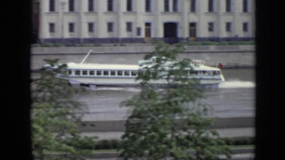 The riverboat continues rightward in the 1971 Moscow view, partly hidden by a tree with a large riverside building behind it.