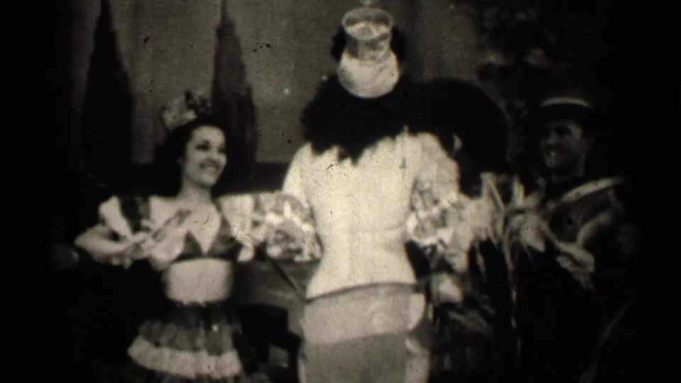 The 1947 Illinois scene shows a smiling grass-skirted performer near a clown-costumed figure and another adult holding ribbon-like props.