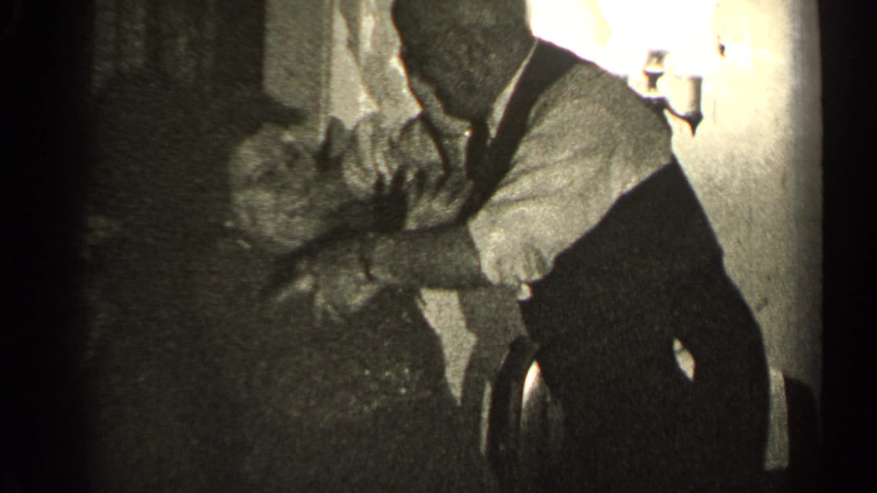 An older man in a vest holds an older woman's hands while they laugh or dance in a dim 1947 Illinois interior.